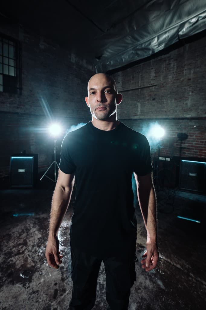 Jacob of Fall of Damascus standing between two stage lights